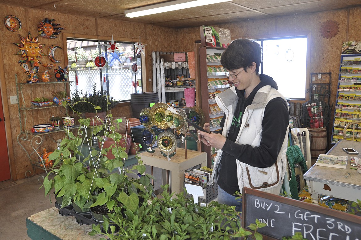 JAMI WILLIAMSON, an employee at South Shore Greenhouse, is also the unofficial &#147;IT&#148; girl, utilizing the business&#146; Facebook page. (Ashley Fox/Lake County Leader)