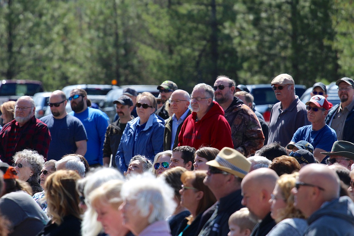 Audience members reflect and listen to the names of the victims.