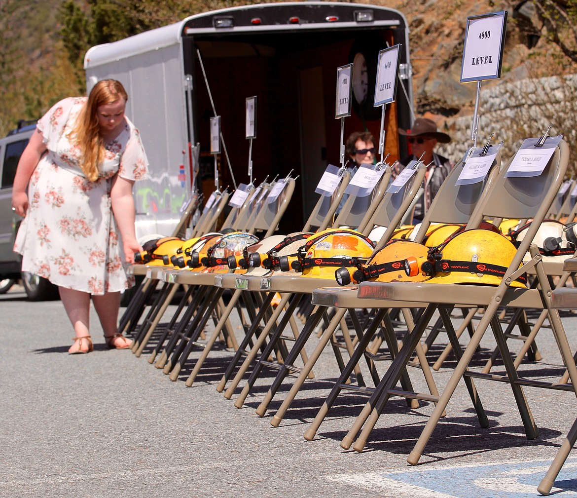 Rylie Gunderson extinguishes the headlamps on the helmets of the deceased miners as their names are read aloud.