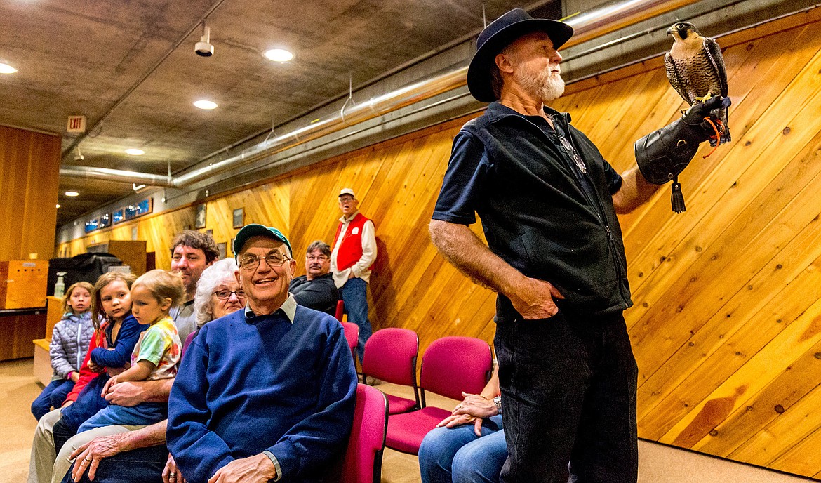 Don Veltkamp, right, displays Pennington, a peregrine falcon, as his wife and colleague Janie Veltkamp teaches a group of people about the raptor at Libby Dam on Saturday, April 28, 2018. (John Blodgett/The Western News)