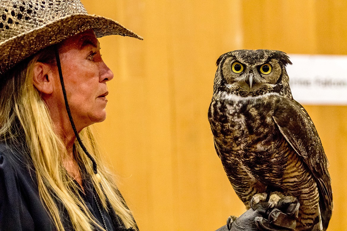 Janie Veltkamp poses for a photo with Bubbah the great-horned owl before giving a presentation at Libby Dam Saturday, April 28, 2018. (John Blodgett/The Western News)