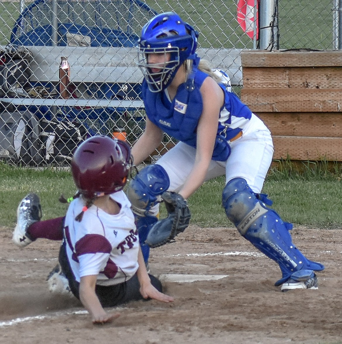 Troy junior Kaylee Tunison slides home to nudge the Troy lead to 7-6 suring the fifth inning of Troy&#146;s 16-13 win over Thompson Falls on Thursday.