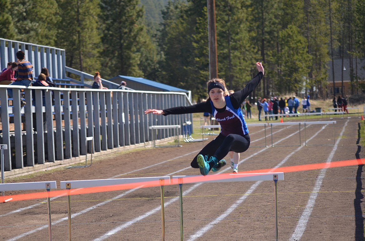 Clark Fork Mountain Cat Bailey Milender, runs in the 100 meter hurdles during a recent track meet in Thompson Fals. During the Seeley Invitational in Frenchtown on April 28 she placed 9 and 10 in the 100 and 300 meter hurdles. (Erin Jusseaume/Clark Fork Valley Press)