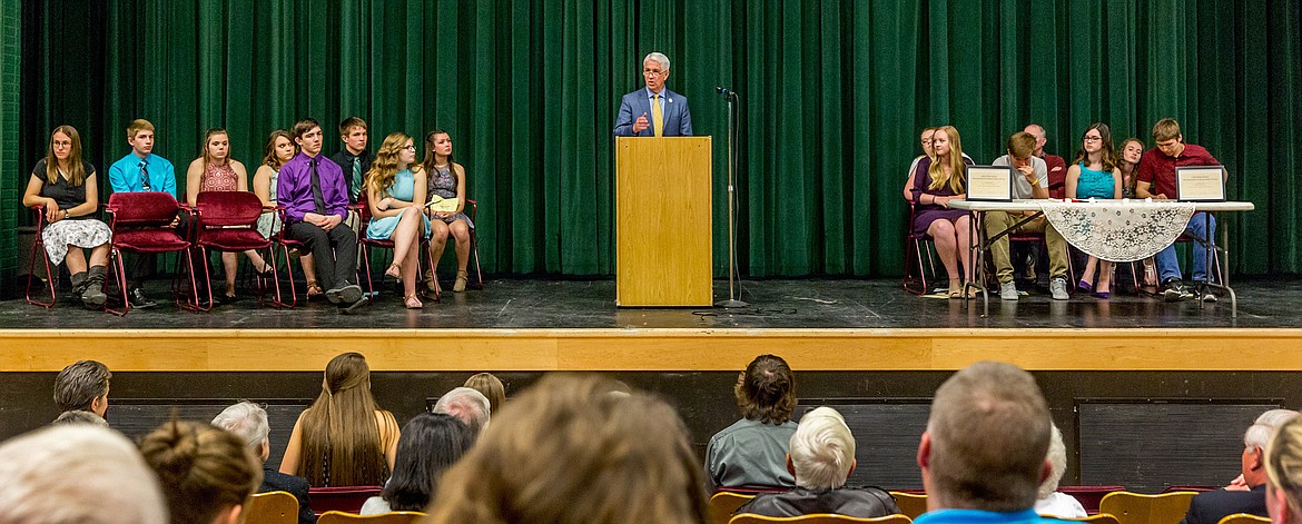 Timothy Fennessey speaks to Libby High School National Honor Society inductees, left, and existing members, right, after being inducted into the school’s Distinguished Graduate Hall of Fame Monday, April 23. (John Blodgett/The Western News)