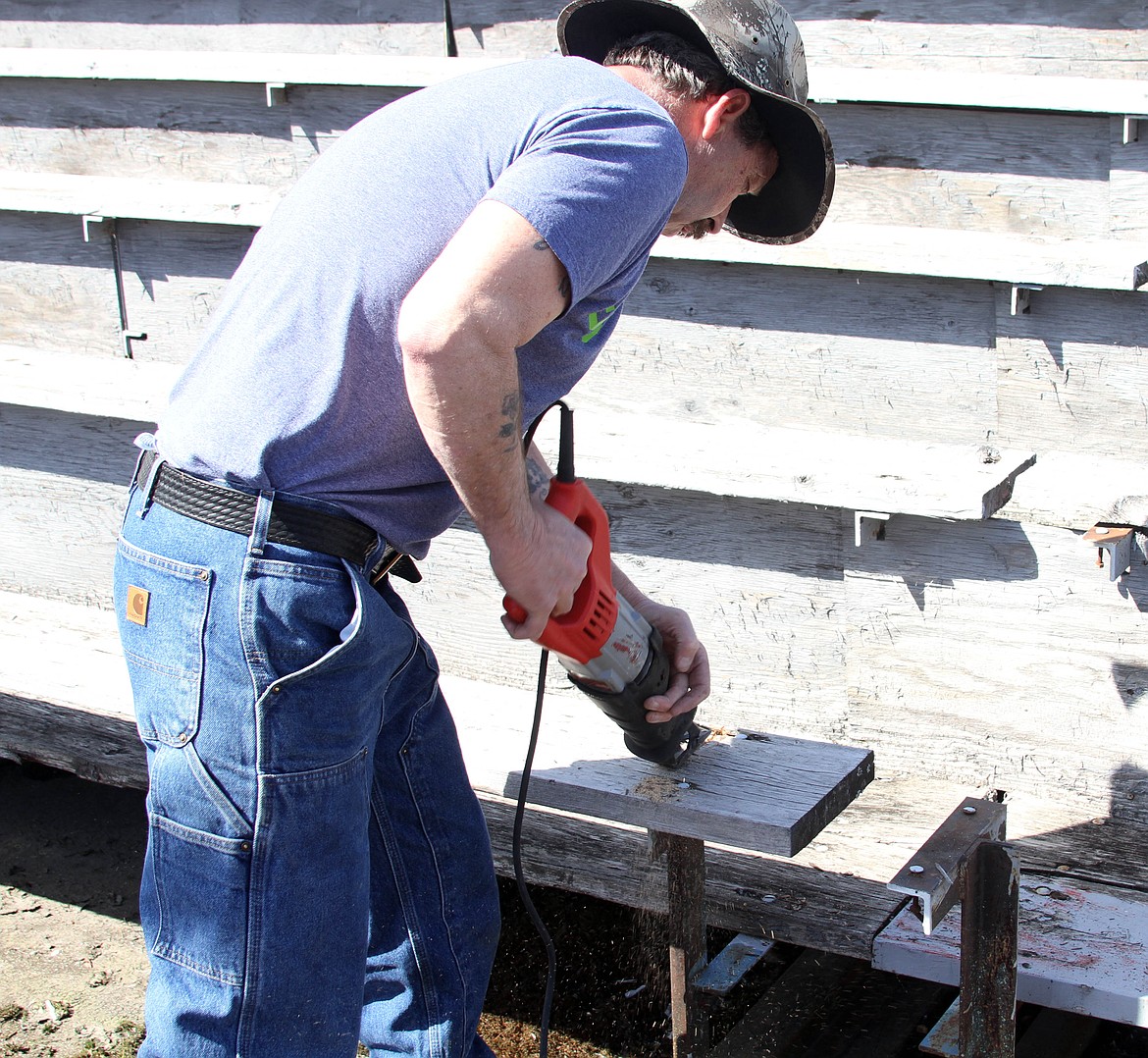 Volunteers helped get the old bleachers torn down so that new boards could be put into place.