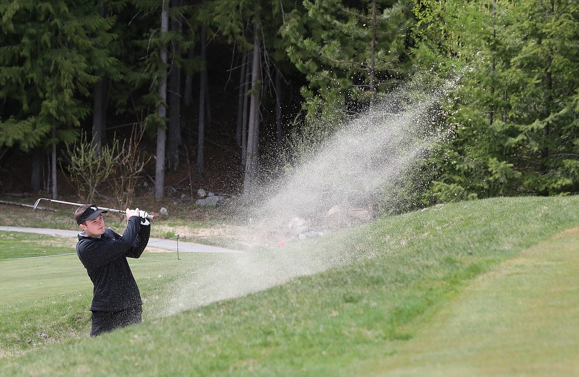 (Photo by ERIC PLUMMER)
Sandpoint&#146;s Nick Crowley blasts out of a sand trap on Monday at the Sandpoint Invitational Monday at The Idaho Club.