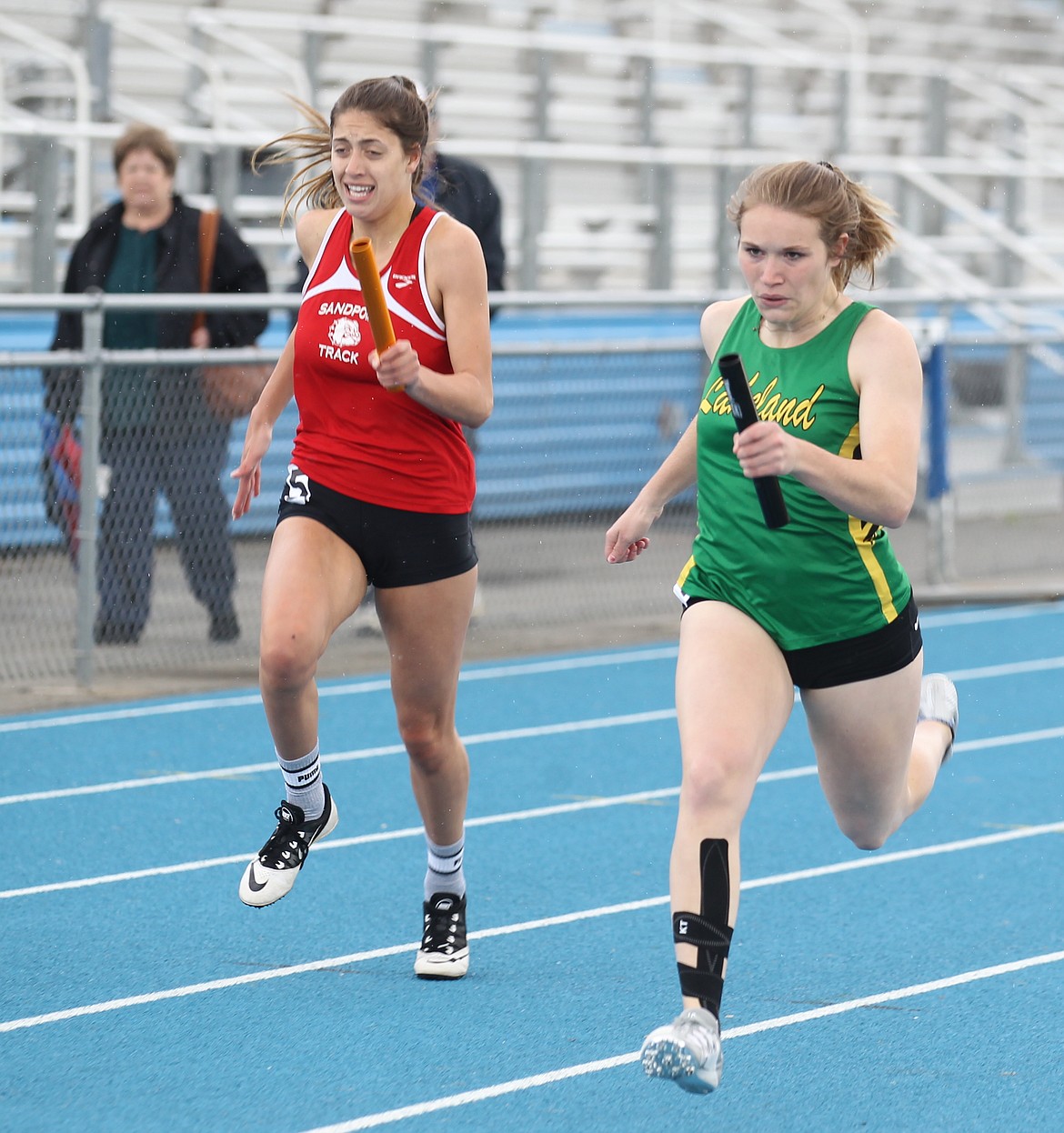 JASON ELLIOTT/Press
Lakeland senior Jillian Mael sprints past Sandpoint&#146;s Jazmin Stockton in the final 50 meters to win the 4x200 relay at the 4A Region 1 meet at Coeur d&#146;Alene High last Thursday.