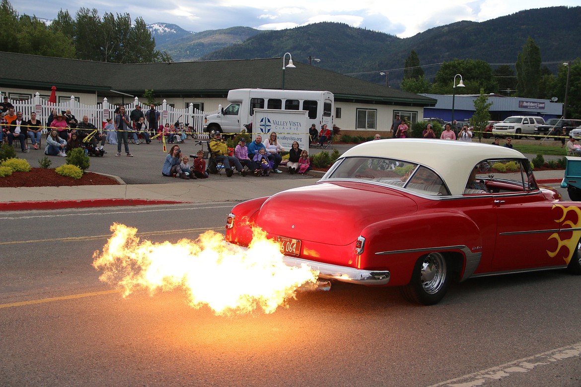 (Photo by MARY MALONE)A classic car throws a bit of flame to the delight of parade watchers on Division Avenue during the Lost in the '50s car parade.