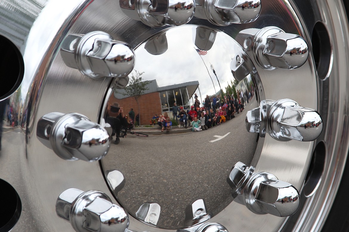 (Photo by KEITH KINNAIRD)
Lost in the 50s spectators are reflected in the hubcap of a classic rig on Friday.