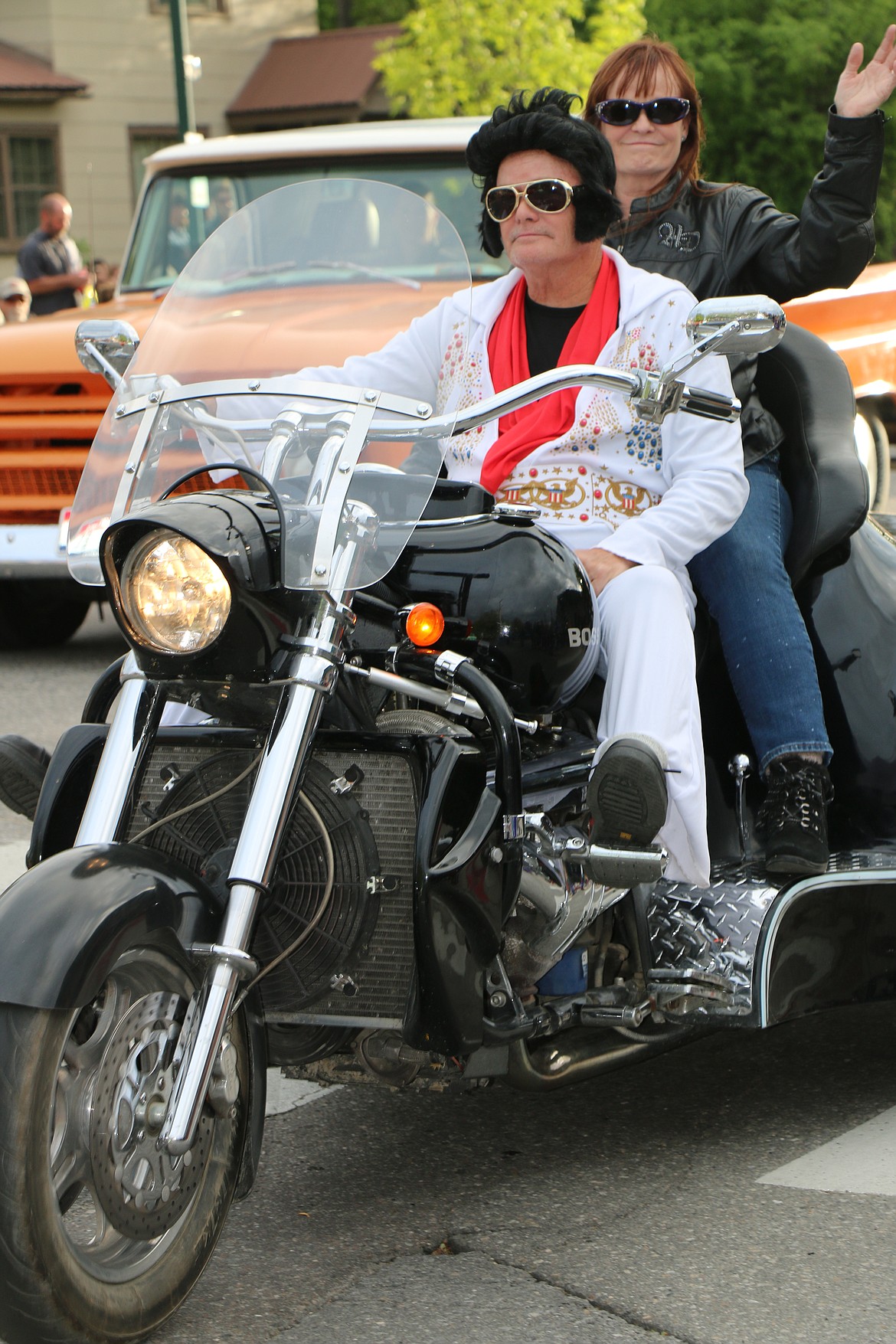 (Photo by CAROLINE LOBSINGER)The King and a friend find time to enjoy the Lost in the '50s parade on Friday.