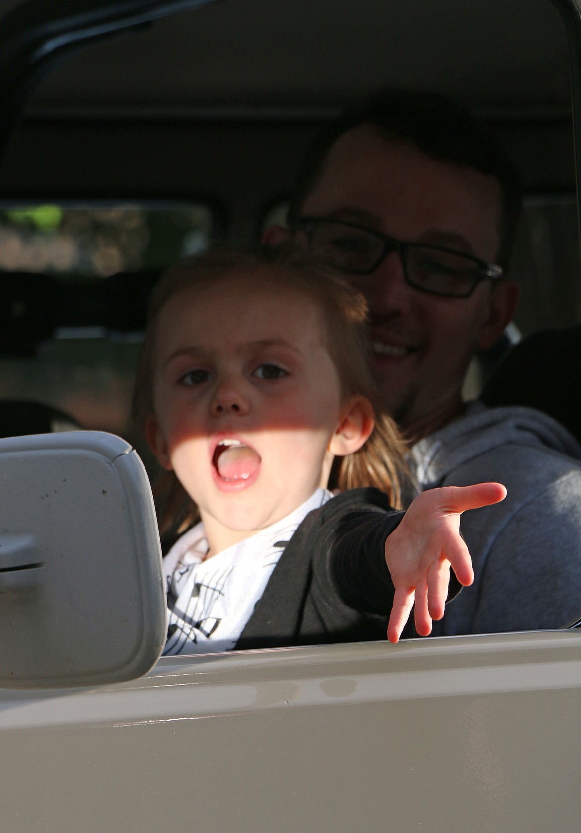 (Photo by CAROLINE LOBSINGER)A participant in the Lost in the '50s car parade blows a kiss to the crowd.