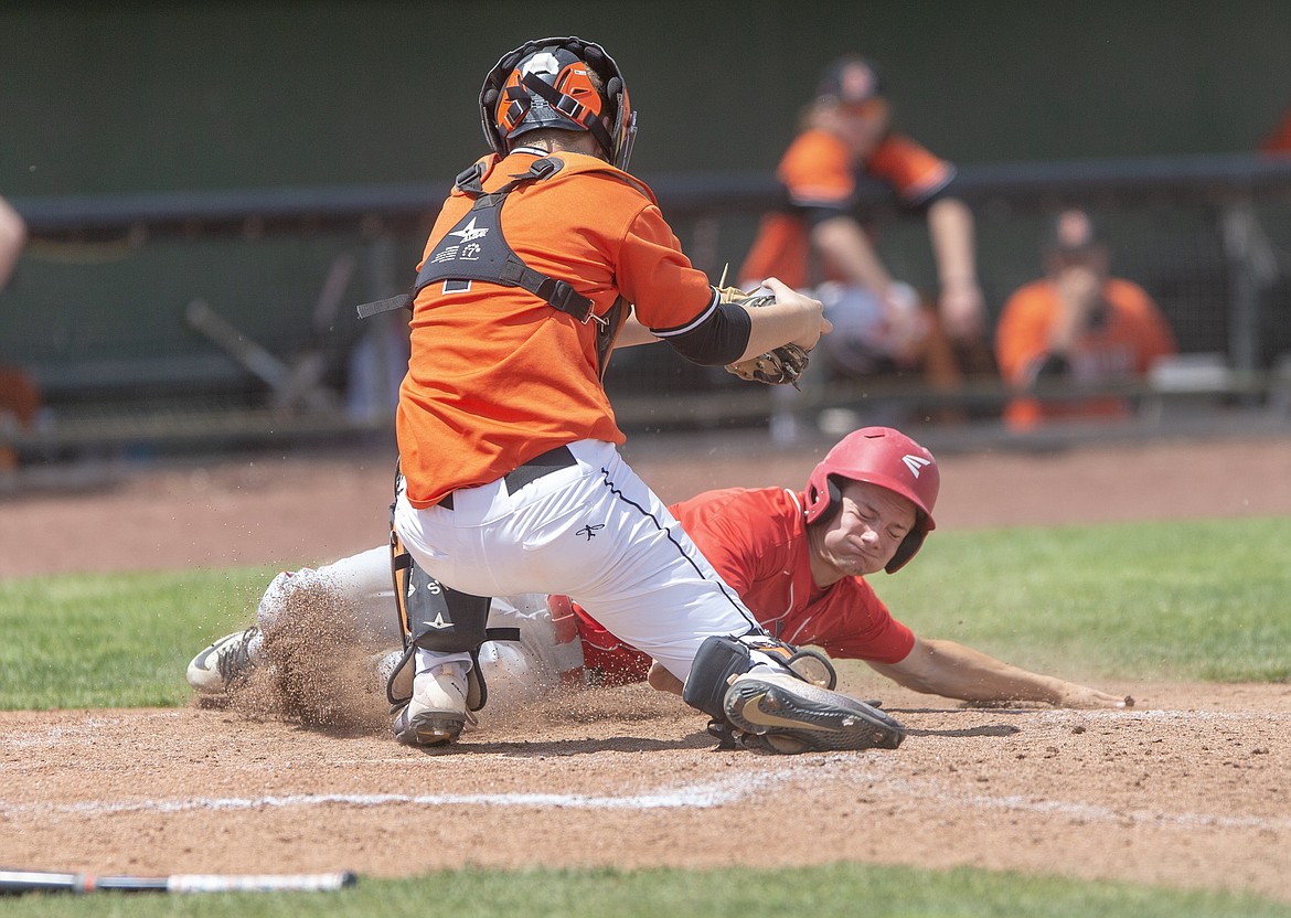 (Photo by JASON DUCHOW PHOTOGRAPHY)
Sandpoint senior Thomas Riley slides home in the Bulldogs&#146; tough season-ending loss to Idaho Falls on Friday.