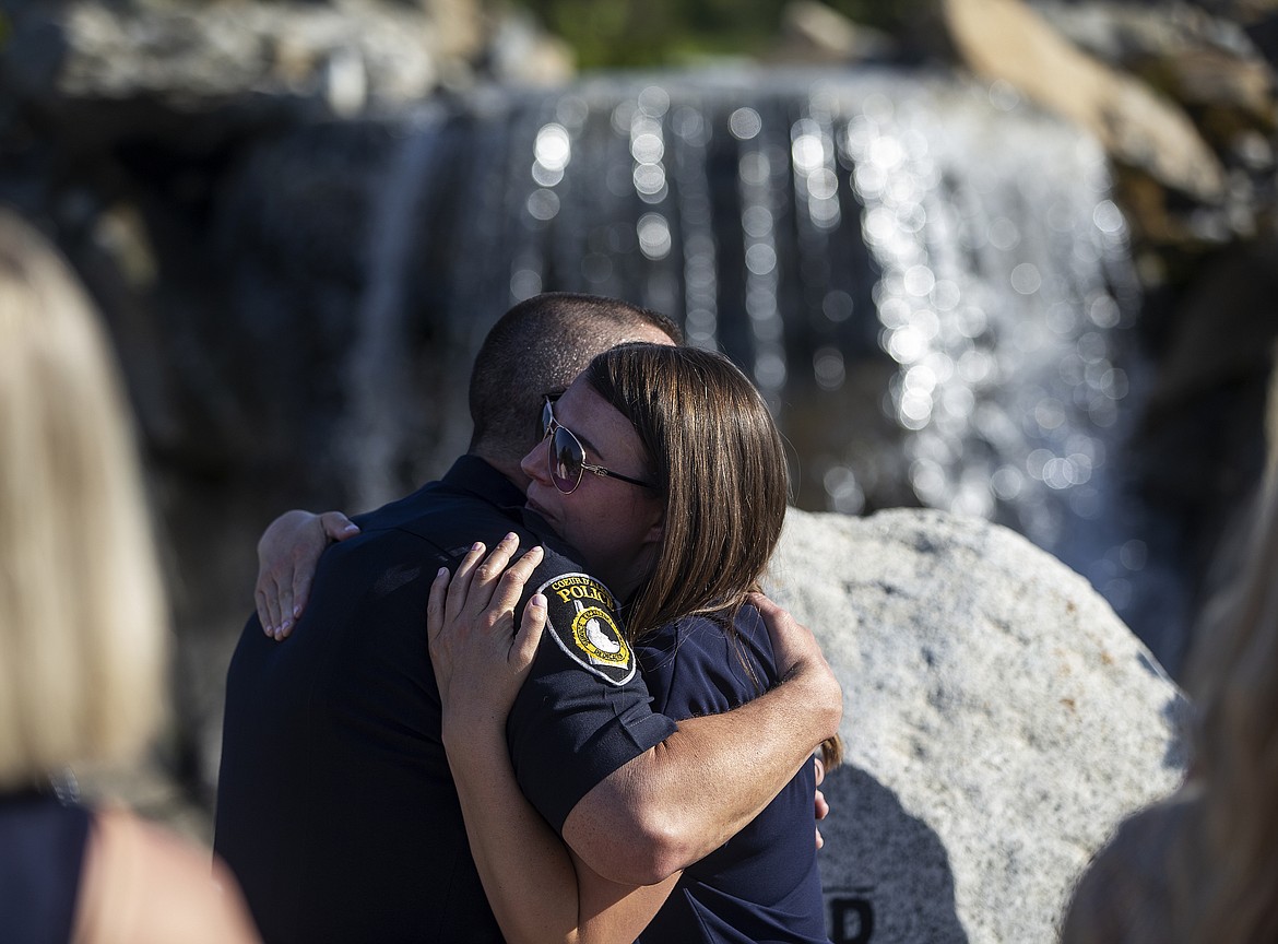 Lindy Moore, wife to Sgt. Greg Moore, gives Lee Bearnard of Coeur d&#146;Alene Police a hug at the end of K27 Forever Memorial dedication in honor of Sgt Greg Moore and other fallen police officers. (LOREN BENOIT/Press)