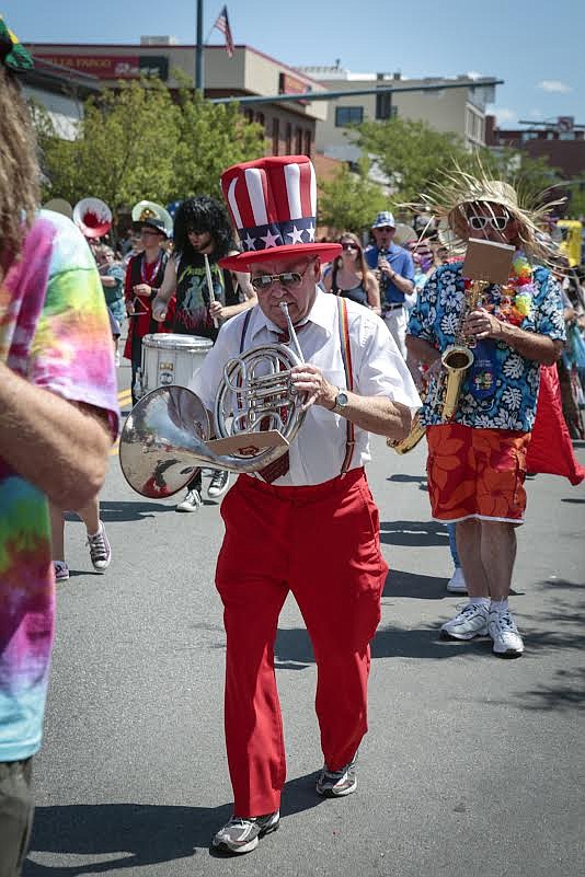 Photo by SHANE YOUNG
Perfection-Nots founder Larry Strobel rocks a patriotic hat and rainbow suspenders as he plays his French horn in a previous Fourth of July parade in downtown Coeur d&#146;Alene. The Coeur d&#146;Alene Chamber of Commerce is now accepting applications for 2018 parade entries. Those interested can register at the chamber office, 105 N. First St. in Coeur d&#146;Alene, or online at www.eventbrite.com by searching &#147;2018 Coeur d&#146;Alene 4th of July Parade Entry Registration&#148; and following the instructions. The deadline for registration and payment is June 1.