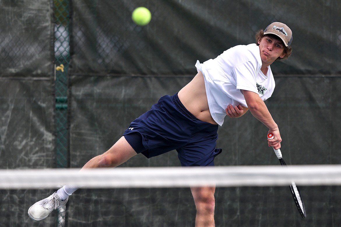 Glacier's Kyle Buckingham serves in a doubles match against Bozeman's Jackson Pedersen and Andrija Martinovic in the Class AA State Tennis Tournament at Flathead Valley Community College in Kalispell on Friday. Buckingham's doubles partner is Tyler Keller. (Casey Kreider/Daily Inter Lake)