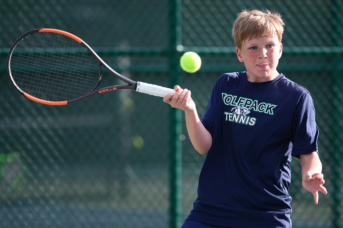 Glacier's Rory Smith hits a return against Helena Capital's Alex Hanson in the Class AA State Tennis Tournament at Flathead Valley Community College in Kalispell on Friday. (Casey Kreider/Daily Inter Lake)