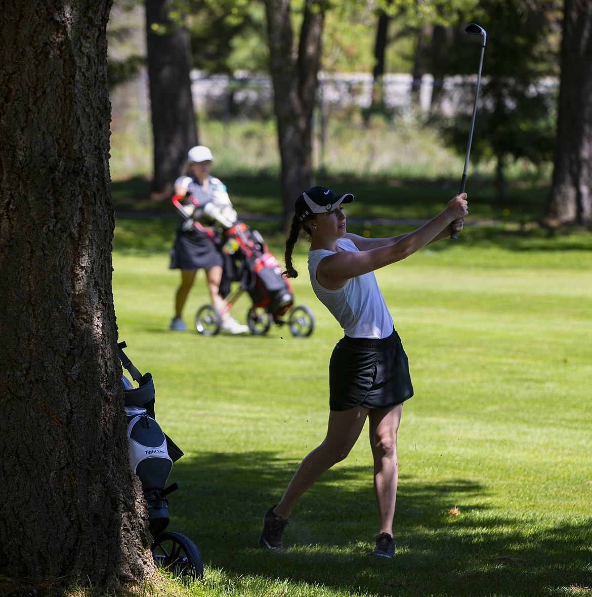 Lilly Kelley of Timberlake watches her iron shot land near the 13th green at the state 3A Tournament at Twin Lakes Village on Tuesday. (LOREN BENOIT/Press)