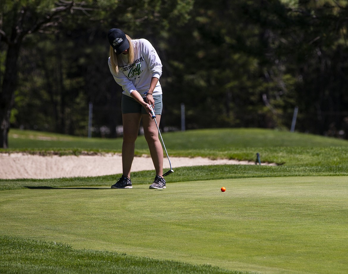 Tatum Qualsund of Timberlake High watches her putt on hole 14 Tuesday morning at the state 3A Tournament at Twin Lakes Village. (LOREN BENOIT/Press)