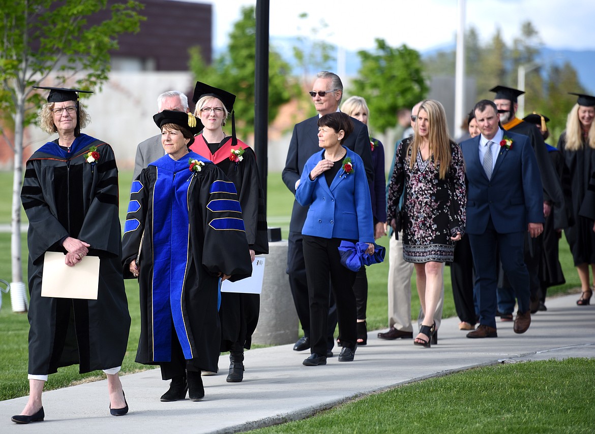 President of Flathead Valley Community College Dr. Jane Karas, members of the board and the college faculty in the processional at the start of the Flathead Valley Community College 50th Commencement Ceremony is about to begin on Friday evening, May 18.(Brenda Ahearn/Daily Inter Lake)