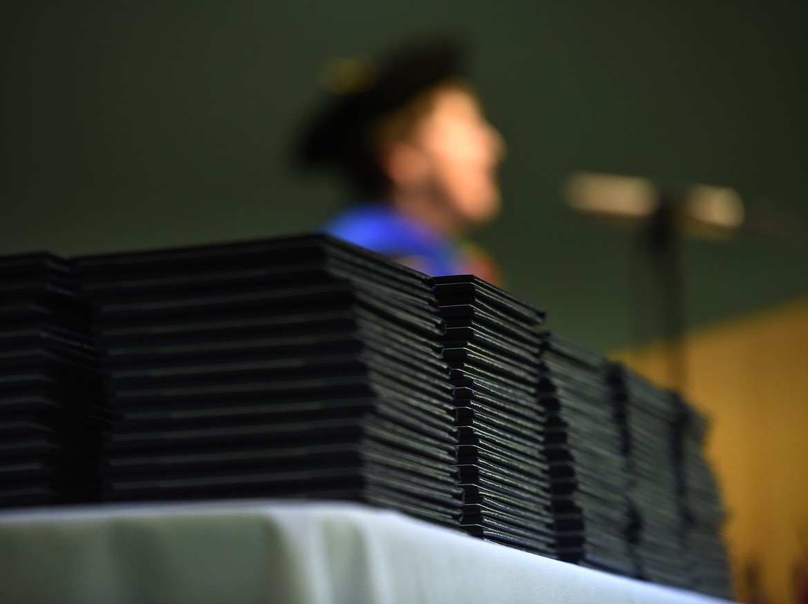 Flathead Valley Community College President Dr. Jane Karas opens the 50th Commencement Ceremony at Flathead Valley Community College on Friday, May 18, in Kalispell. In the foreground are the 368 degrees and certificates to be award later that evening.(Brenda Ahearn/Daily Inter Lake)