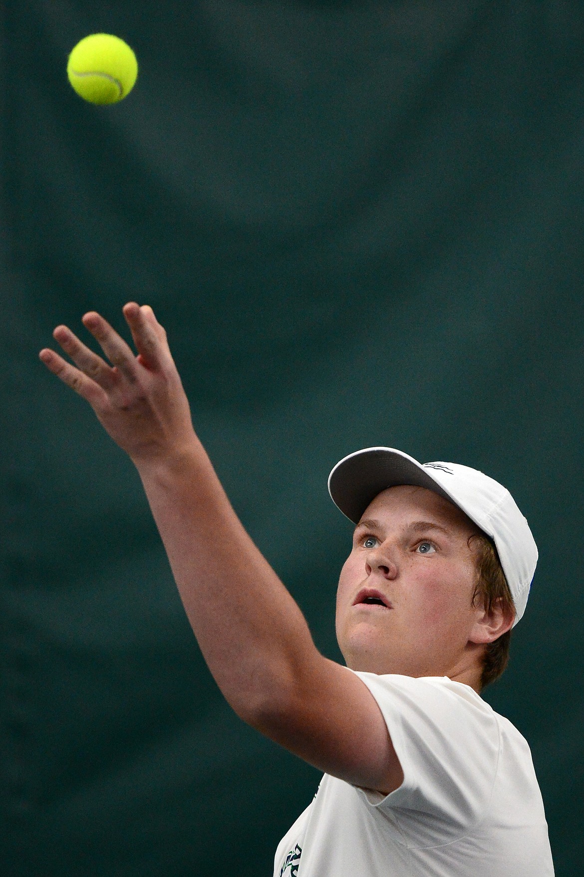 Glacier&#146;s Hunter Watterud serves during a first round doubles match with Helena&#146;s Alex Seburn and Evan Martin at the 2018 AA State Tennis Tournament in Kalispell on Thursday. Watterud&#146;s doubles partner was Morgan Cordell. (Casey Kreider/Daily Inter Lake)