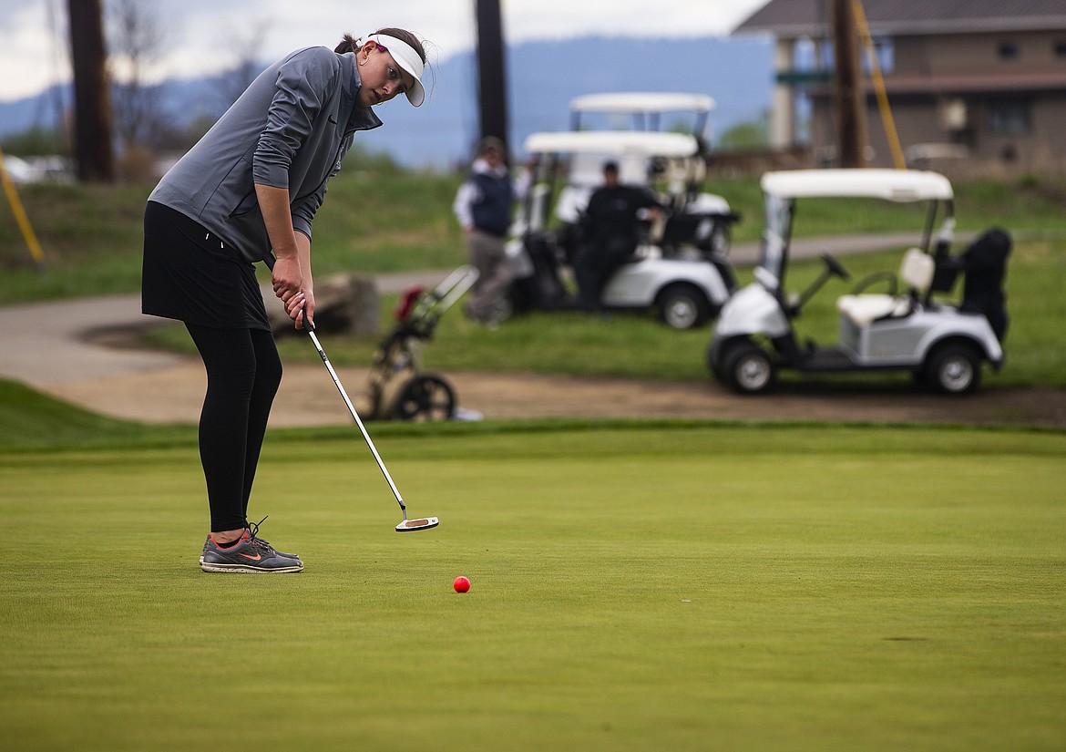 Josie Scribner of Genesis Prep eyes her putt on the ninth hole Monday morning at the 2A District 1 tournament.