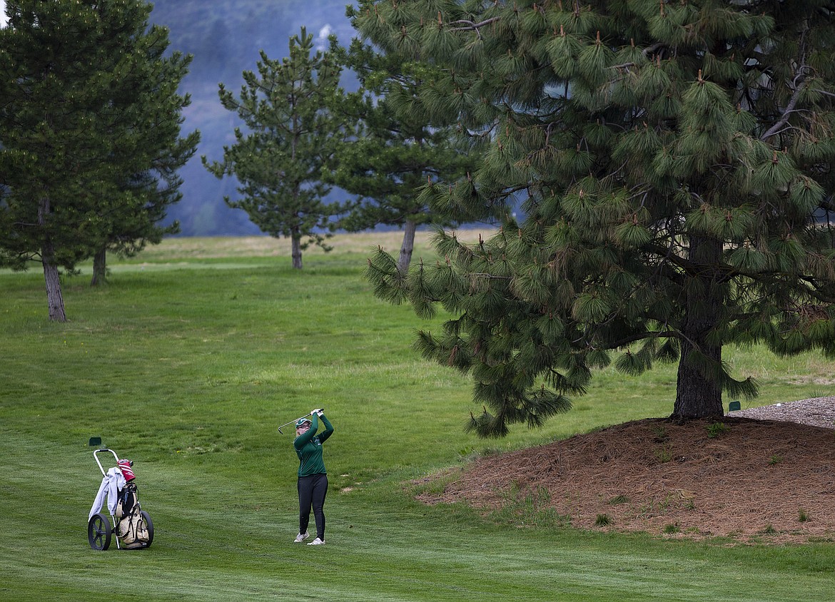 Tabitha Boller of St. Maries watches her iron shot land near the ninth green Monday at the 2A District 1 tournament at The Links Golf Club.