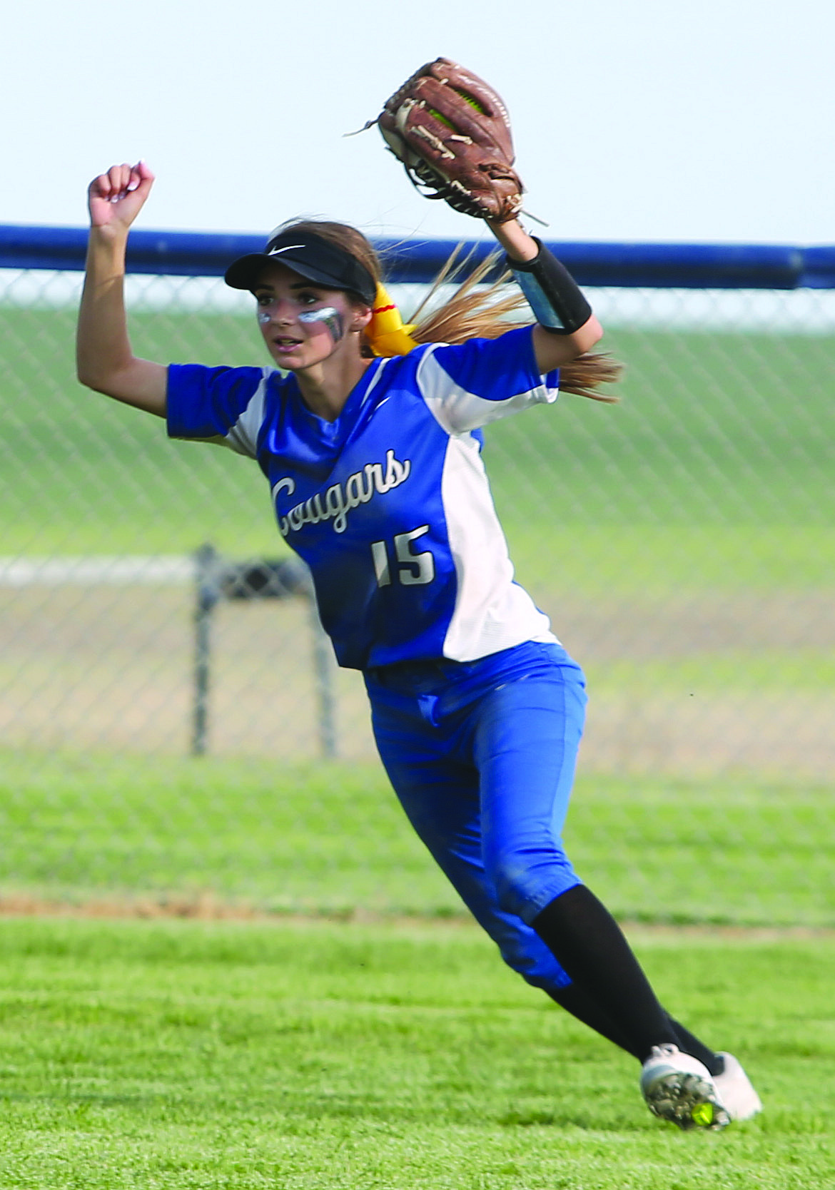 Connor Vanderweyst/Columbia Basin Herald
Warden outfielder Leanne Martinez raises her arms in triumph after she catches the final out against Naches Valley.