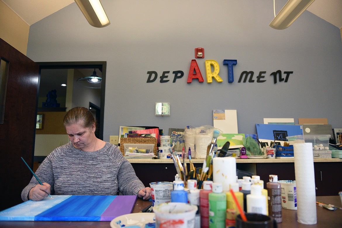 Dolores Aderman works on a painting for the &#147;Stomp the Stigma&#148; Art Show at the Western Montana Mental Health Center in Kalispell on Thursday, May 10. (Casey Kreider/Daily Inter Lake)