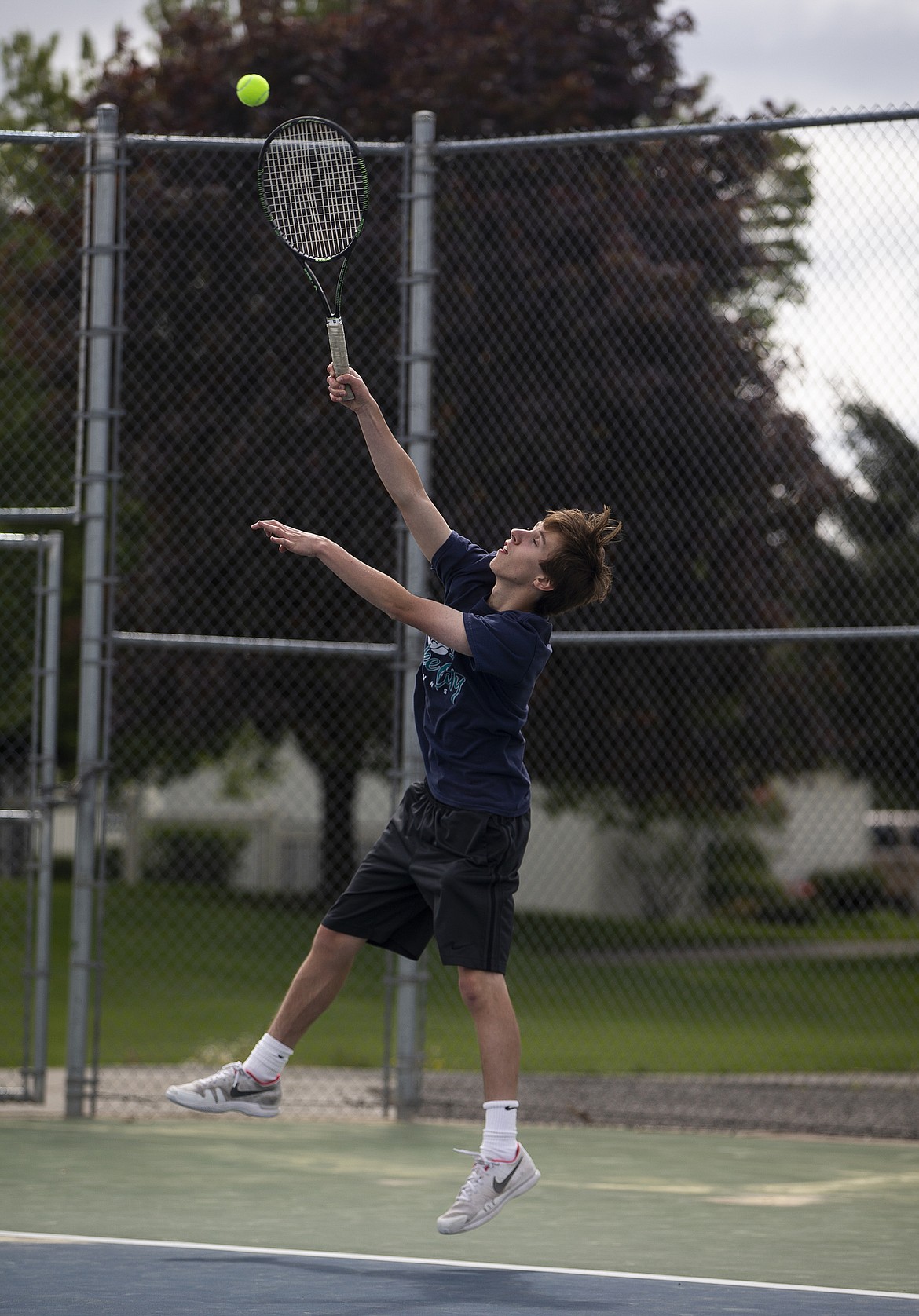 Paul Wineinger of Lake City High hits a serve in a boys doubles match at the 5A Region 1 tournament Friday at Lake City High. (LOREN BENOIT/Press)