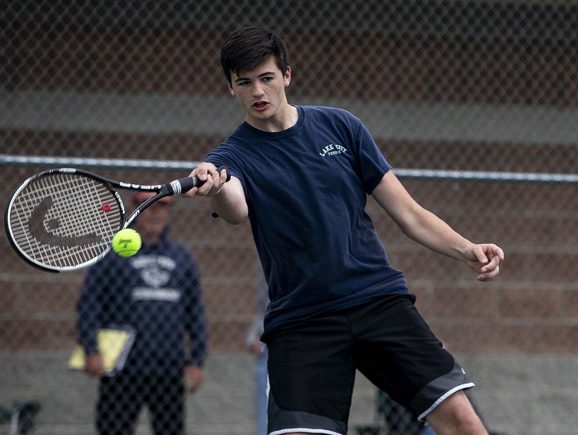 Daniel Alvera of Lake City High hits a return in a boys doubles match at the 5A Region 1 tournament at Lake City High on Friday. (LOREN BENOIT/Press)