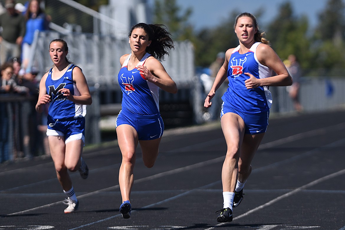 Bigfork's Haile Norred, right, took first in the girls 100 meter dash at the Bigfork Invitational track and field meet on Saturday. (Casey Kreider/Daily Inter Lake)