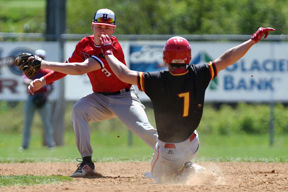 Kalispell's Randy Stultz steals second base ahead of the tag by Helena shortstop Colin Sassano at Griffin Field on Saturday. (Casey Kreider/Daily Inter Lake)