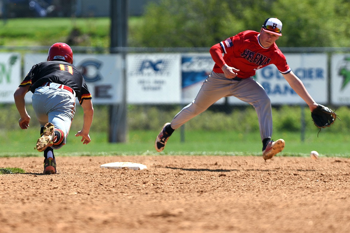 Kalispell's Brandon Jordan steals second base as the throw eludes Helena shortstop Colin Sassano on Saturday. (Casey Kreider/Daily Inter Lake)