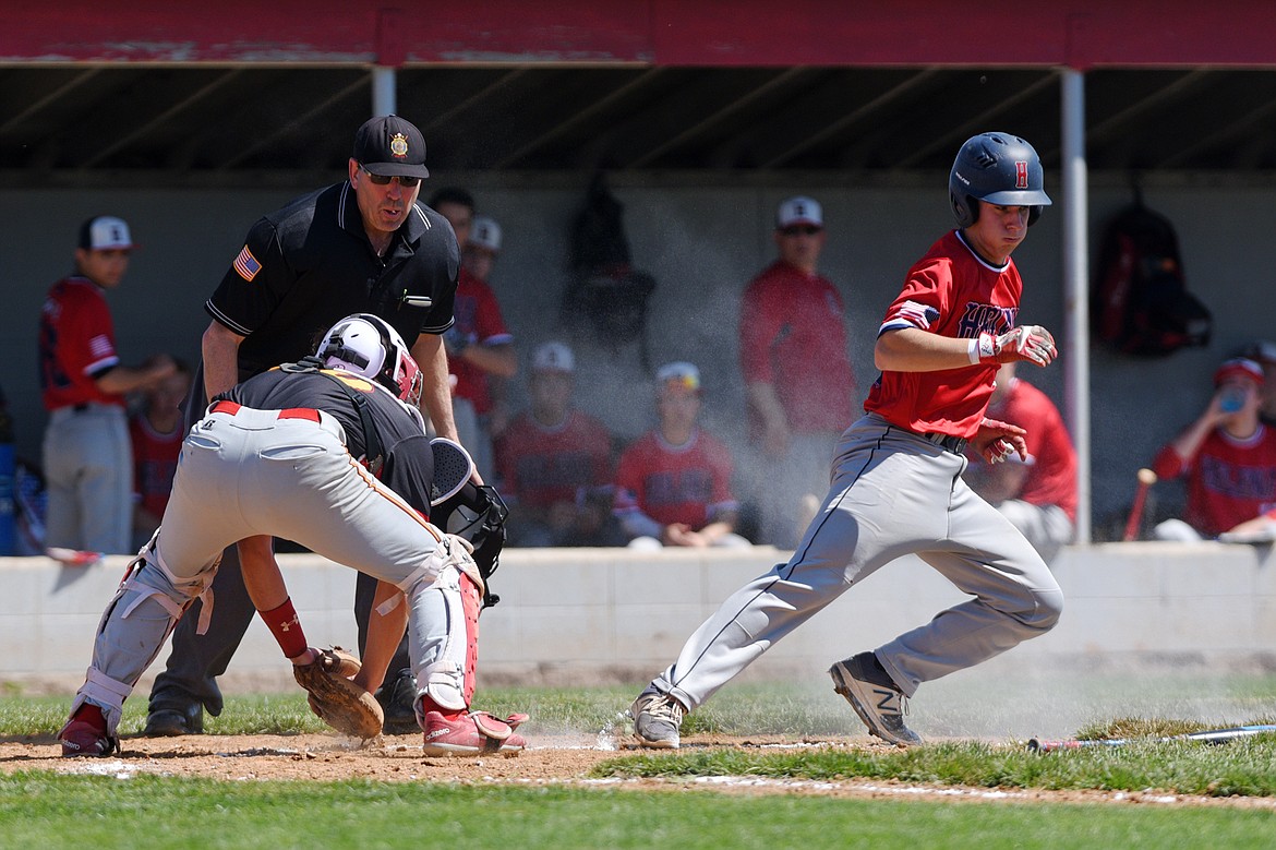 Helena's Kadyn Craigle gets caught in a rundown between home and third by Kalispell Lakers catcher Keaden Morisaki on Saturday. (Casey Kreider/Daily Inter Lake)