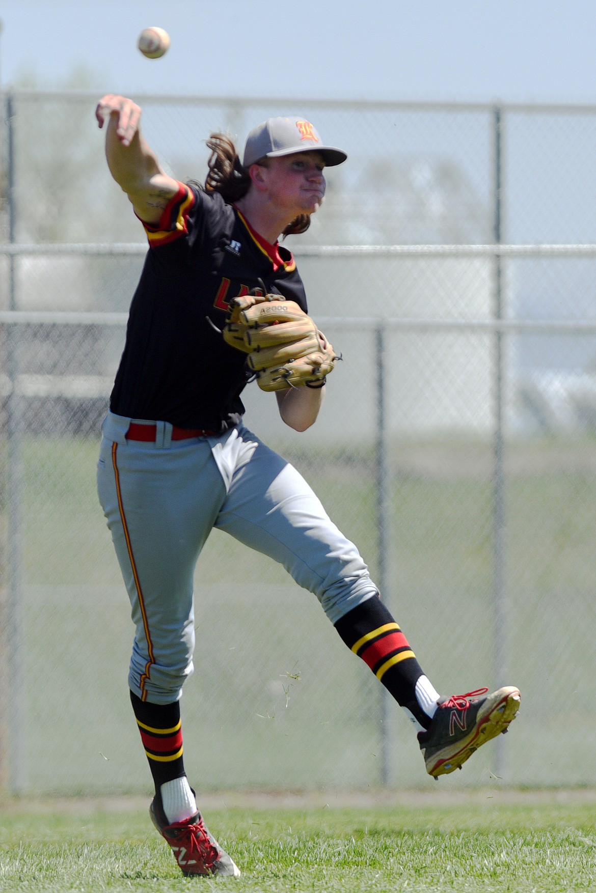 Kalispell third baseman Evan Todd throws to first after fielding a bunt against Helena at Griffin Field on Saturday. (Casey Kreider/Daily Inter Lake)