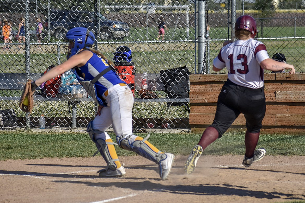 Troy junior Tristyn Winebark crosses home plate safe after dash from second on a single by Hermes in the fourth inning. (Ben Kibbey/The Western News)