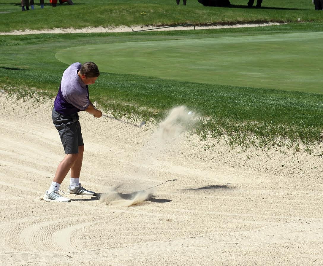 Taylor Bush chips one from the sand on hole 18 during the 3A state golf competition.