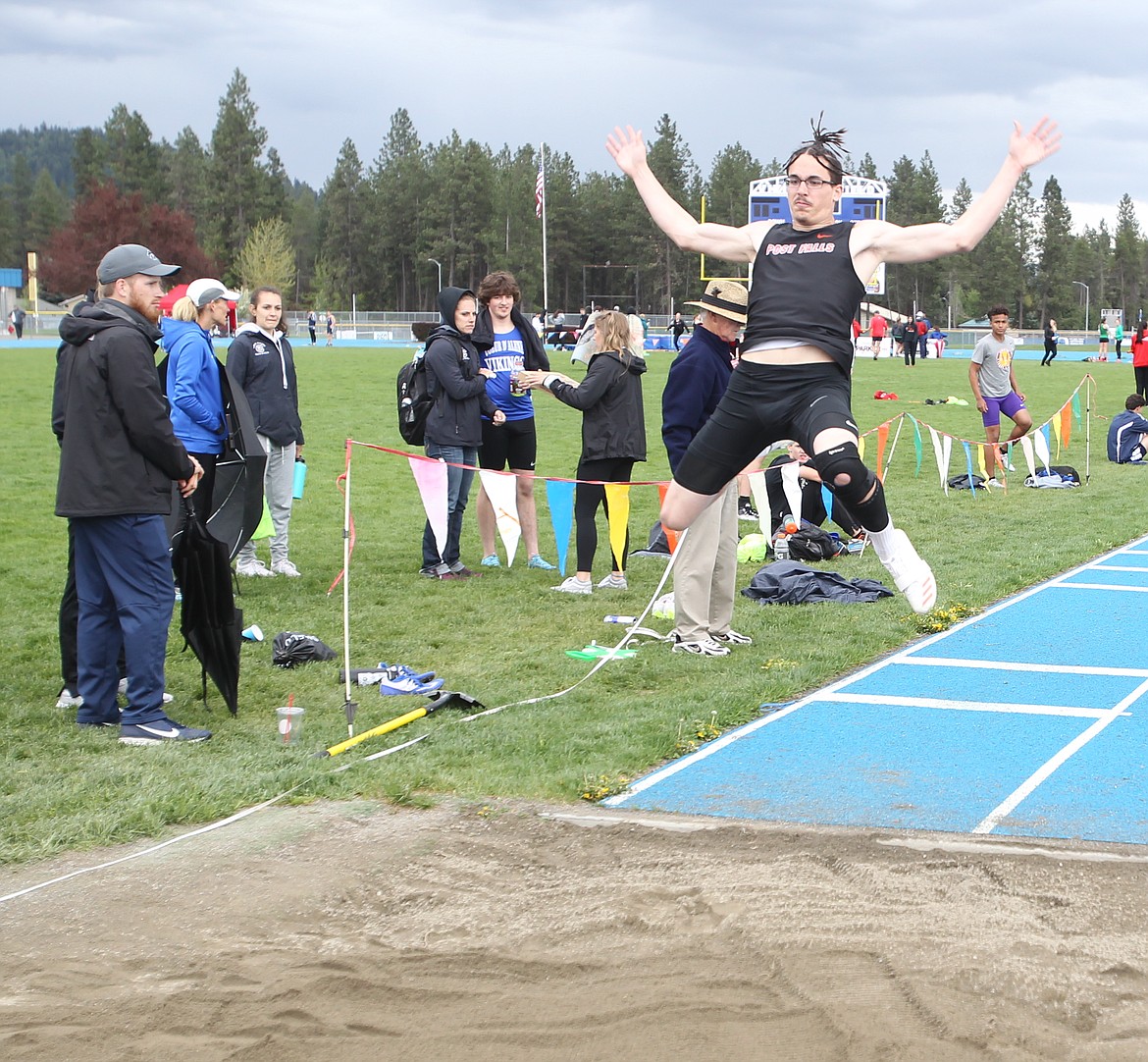 Post Falls junior Tyler Trengove extends his arms to reach 22-feet even in the 5A boys long jump at Thursday&#146;s Region 1 meet at Coeur d&#146;Alene High.

JASON ELLIOTT/Press