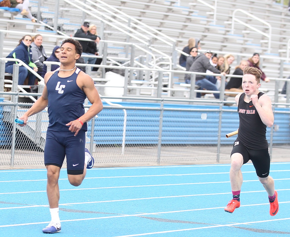 JASON ELLIOTT/Press
Lake City&#146;s Grant Clark sprints down the final stretch in front of Post Falls&#146; Victor Kasner during the 4x200 relay of the 5A Region 1 meet on Thursday at Coeur d&#146;Alene High. Lake City finished second to Lewiston, followed by Post Falls in third.