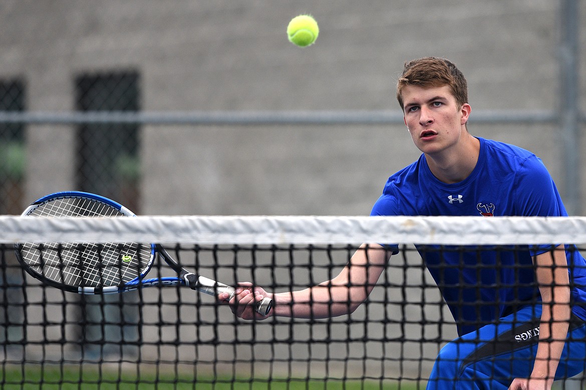 Bigfork&#146;s Colton Reichenbach hits a return at the net against Troy&#146;s doubles pairing of Cy Winslow and Jaymin Stever at Montana Athletic Club-Bigfork on Friday. Reichenbach&#146;s doubles teammate was Clayton Reichenbach. (Casey Kreider/Daily Inter Lake).