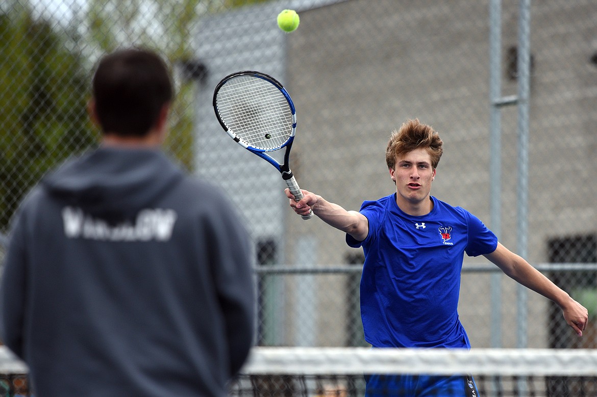 Bigfork&#146;s Clayton Reichenbach hits a return against Troy&#146;s doubles pairing of Cy Winslow and Jaymin Stever at Montana Athletic Club-Bigfork on Friday. Reichenbach&#146;s doubles teammate was Colton Reichenbach. (Casey Kreider/Daily Inter Lake).