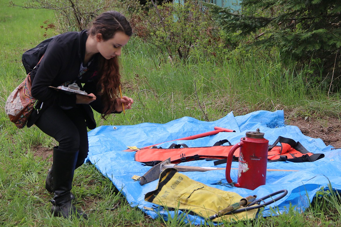 (Photo by MARY MALONE)
Post Falls Middle School eighth-grader Hailey Sims looks closely at some items spread out in the tool identification portion of the Idaho State Forestry Contest on Thursday.