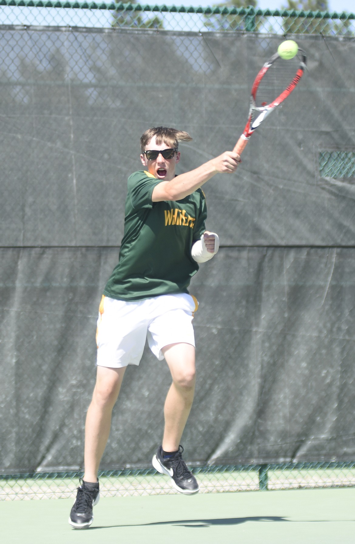 Colter Upton rifles the ball back in a doubles match against Hamilton on Saturday.