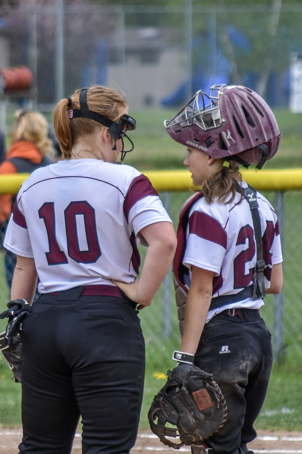 In the fourth inning of Troy&#146;s first game against Eureka friday, junior catcher Kaylee Tunison calls a timeout to talk with sophomore pitcher Mazzy Hermes.  (Benjamin Kibbey/The Western News)