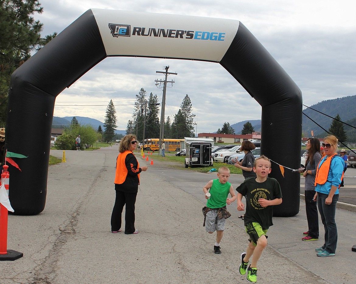 Chet Hill, grade 1, and Connor Lulis, grade 3, from St. Regis crossed the finish line together after running the mile during the Mineral County Fun Run on May 9 in Superior.