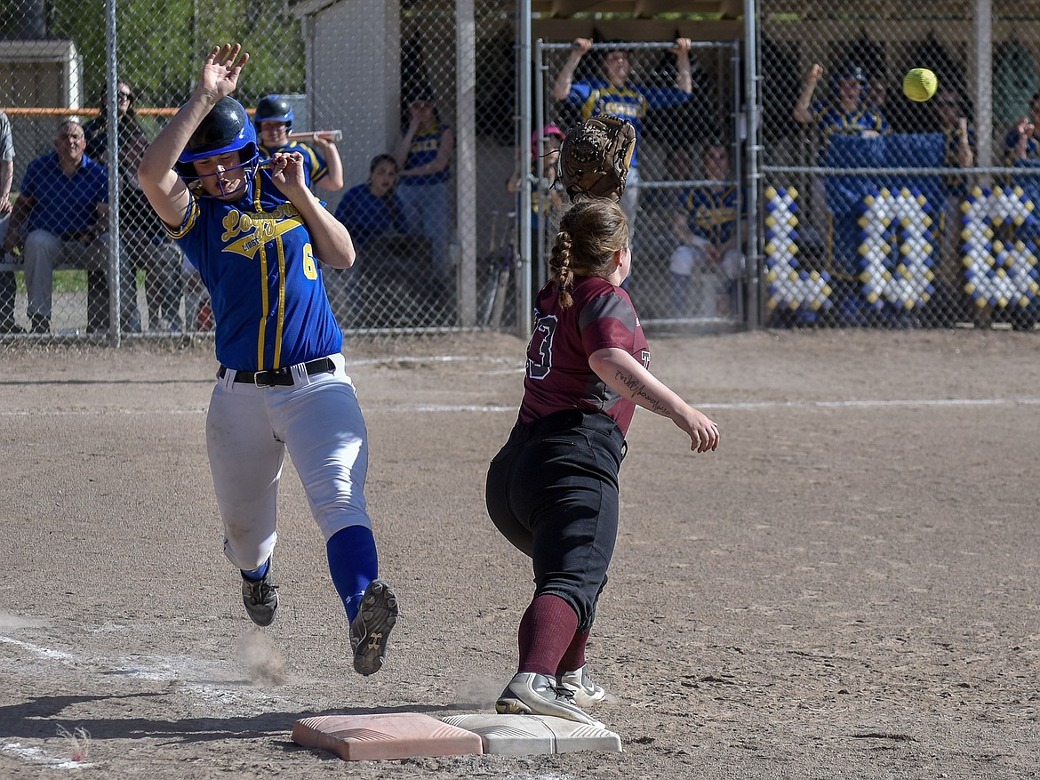 Libby sophomore McKenzie Proffit stretches for first base and is called safe on a grounder to Troy freshman shortstop Talise Becquart that was thrown to junior first baseman Tristyn Winebark during the fourth inning of the first game of the Libby-Troy double header Tuesday, May 8. Profit&#146;s single brought in sophomore Kiera Ward, making the score 8-3, Libby. (Ben Kibbey/The Western News)