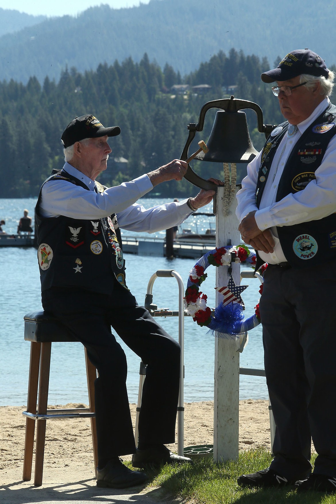 With Jerry Parker looking on, Tom DePew tolled the bell for U.S. submarines lost at sea during a Memorial Day ceremony at Lake Hayden Monday. (JUDD WILSON/Press)