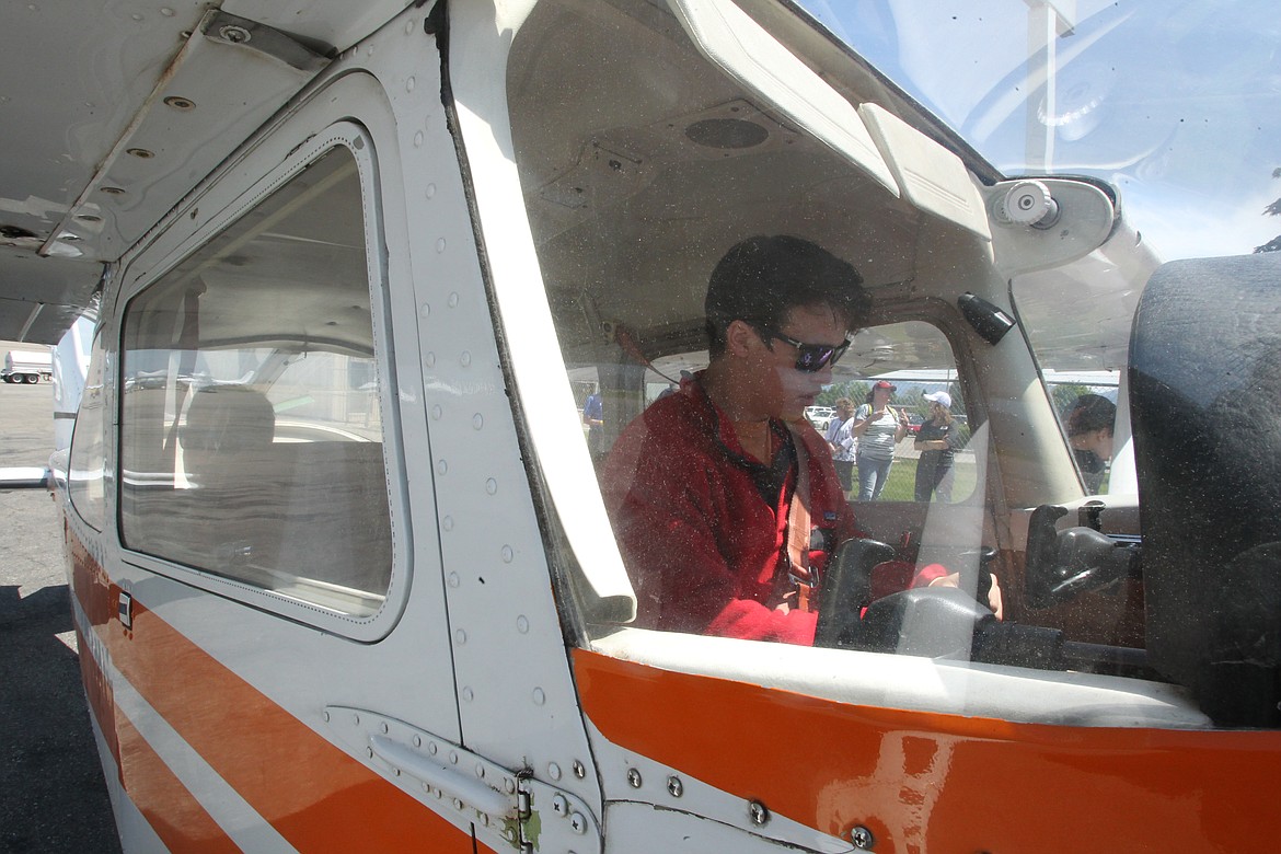 In the cockpit of a Cessna 172, 17-year-old Riley Stevens prepares for takeoff Saturday afternoon. Riley is the 1,021st graduate of the S.O.A.R.I.N.G. program, which is celebrating its 25th anniversary this year. Riley and his brother and sister, with guidance from flight instructor Darrell Kisler, were in the air for about a half hour with Riley in the pilot&#146;s seat. (DEVIN WEEKS/Press)