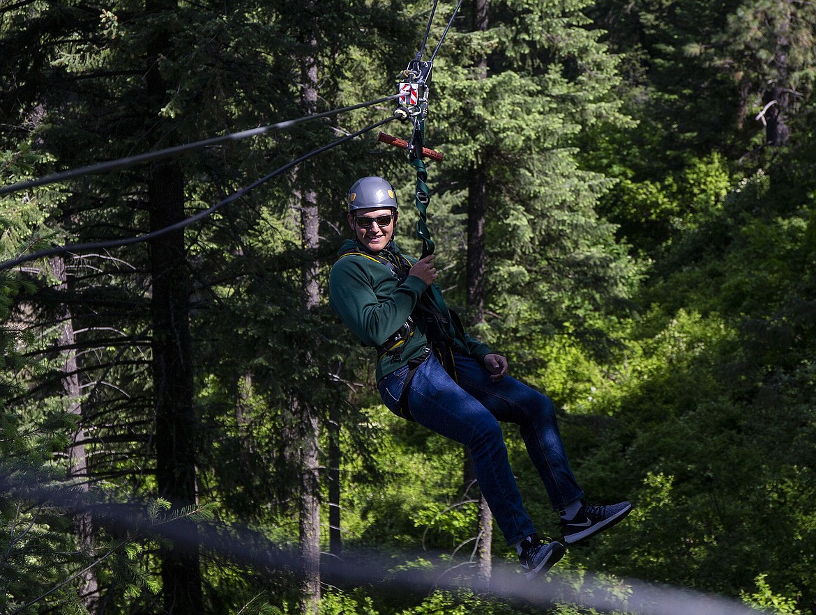 Lake City High School student Conner Conigliaro zips across a line during an academic math field trip to Timberline Adventures by Beauty Bay on Thursday. (LOREN BENOIT/Press)